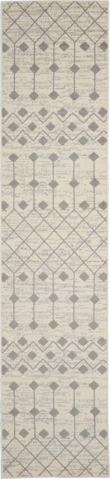 Close-up of Nourison Grafix Ivory/Grey rug. Bohemian design with diamond and geometric patterns. Neutral colors, soft texture.