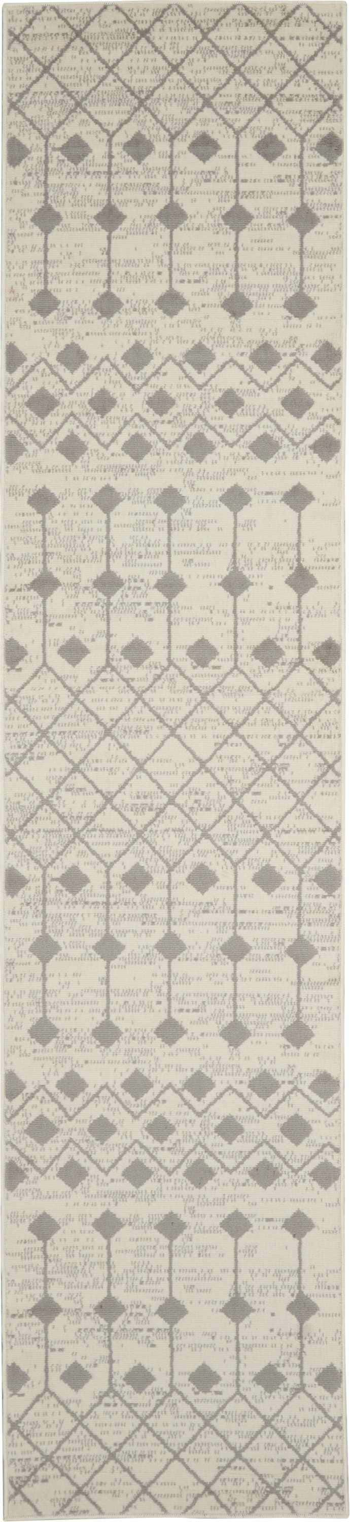 Close-up of Nourison Grafix Ivory/Grey rug. Bohemian design with diamond and geometric patterns. Neutral colors, soft texture.