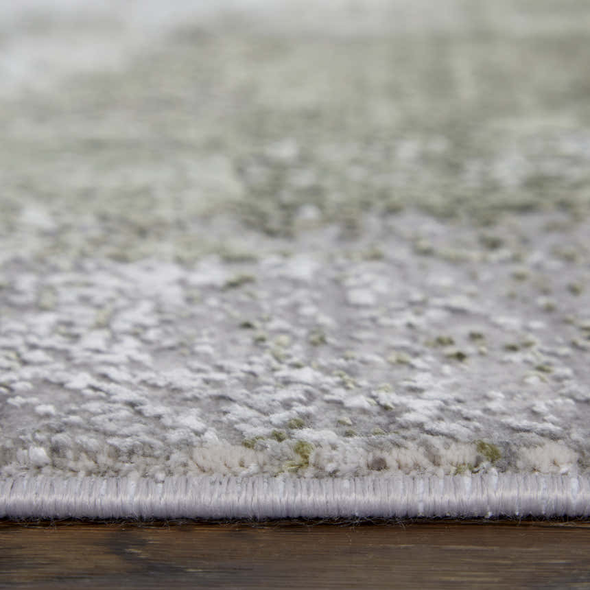 Close-up of the Feizy Cadiz rug showing the gray, green, and silver ikat pattern and soft, textured pile. Pile