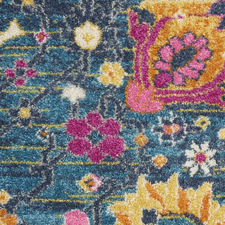Close up of the Nourison Passion Denim Bohemian Area Rug. Features floral pattern in denim, pink, and yellow.