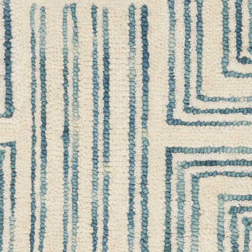 Close-up of Nourison Interlock Ivory/Turquoise rug showing wool texture and modern geometric pattern.