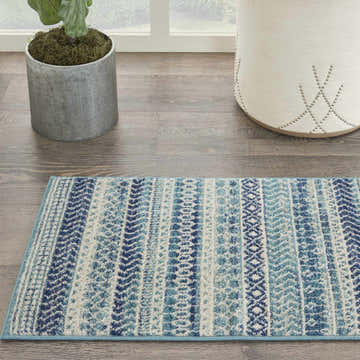 Close-up of Nourison Passion Navy Blue rug runner with a bohemian stripe pattern in navy, blue, and white.
