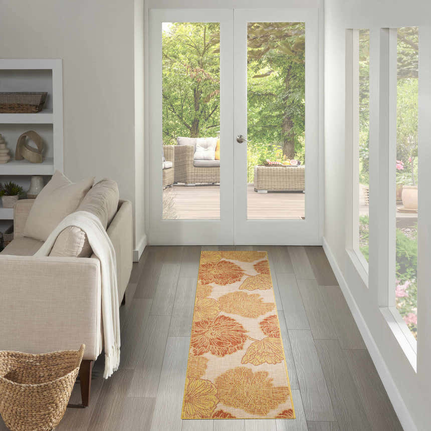 Hallway with a Nourison Garden Oasis Coral Tropical runner rug leading to an outdoor patio.
