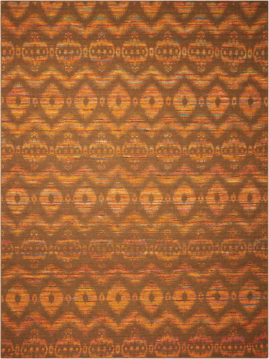 Close-up of Nourison Spectrum Flame Chocolate rug. Features bamboo, wool, and cotton with orange and brown tribal pattern.