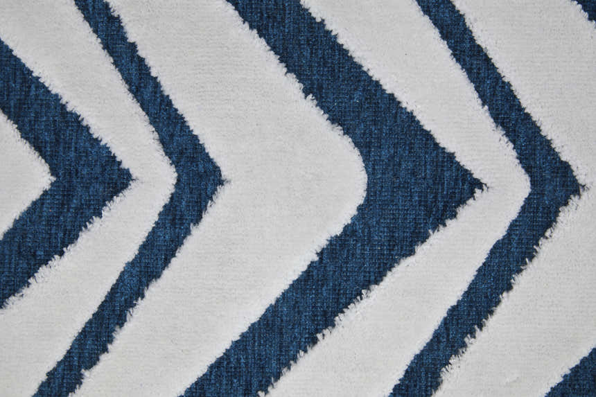 Close up of Feizy Saphir Mira rug with a modern diamond pattern in blue and white. Soft texture. Texture