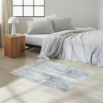 Modern bedroom with Calvin Klein CK005 Enchanting Seaglass rug, light wood floors, and neutral bedding.