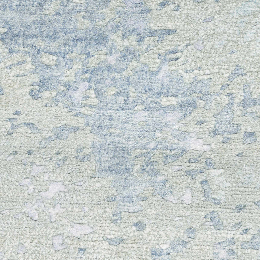 Close-up of the Nourison Silk Shadows Blue Green rug, showing its abstract pattern and textured, silk-like fibers.