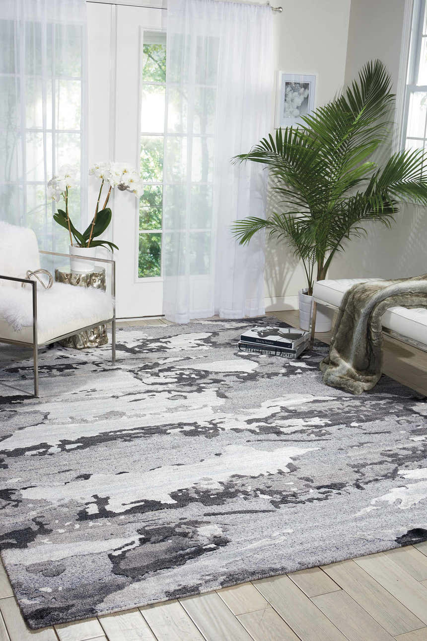 Bright living room with a gray and white Nourison Divine Smoke Modern Area Rug.