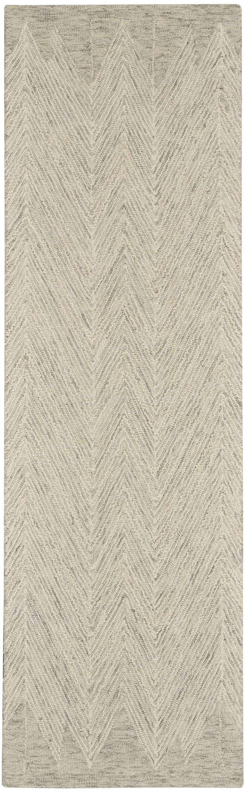 Close-up of the Nourison Interlock Ivory/Grey rug. Features a modern chevron pattern and textured wool weave.
