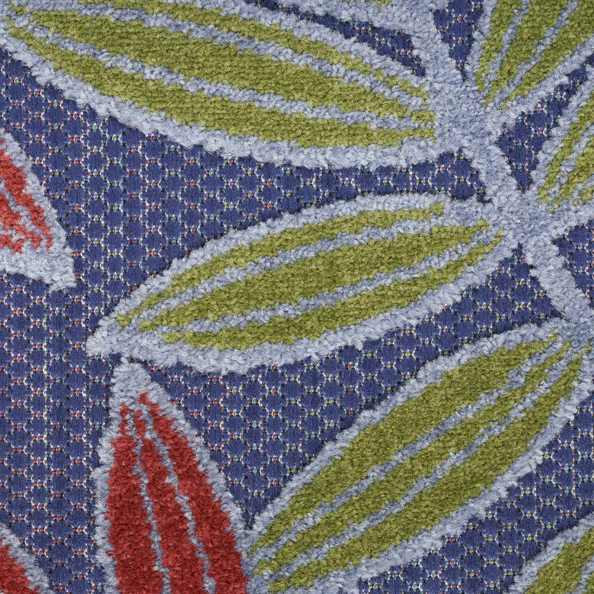 Close-up of the Nourison Aloha Navy Multicolor Outdoor Area Rug featuring a leaf pattern in green, red, and blue.