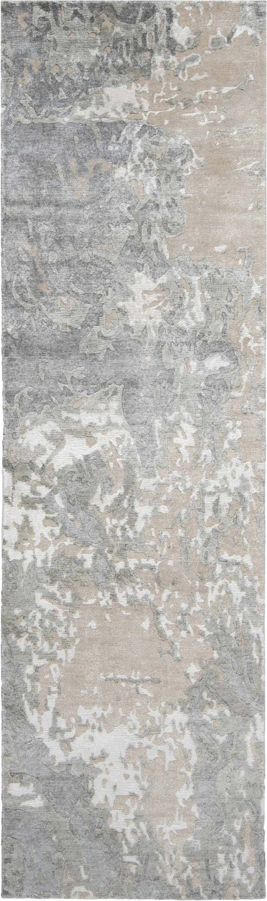 Close-up of the Nourison Silk Shadows Sand rug. Abstract sandstone, gray, and white pattern. Handmade, silk-like texture.