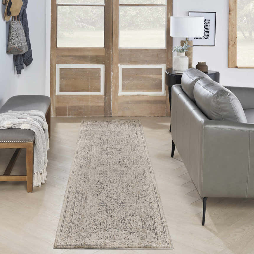 Entryway with grey bench and sofa featuring Nourison Lynx Ivory Grey Blue Vintage Indoor Area Rug runner.