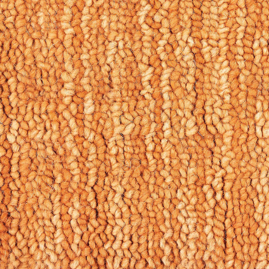 Close-up of the handmade Nourison Marana Sunset rug, showcasing its wool texture and sunset orange color.