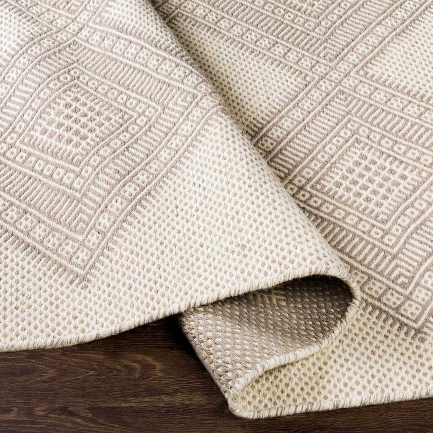 Close-up of the hand woven Aanislag Cream Wool Runner showing its geometric pattern and textured wool fibers. Fold