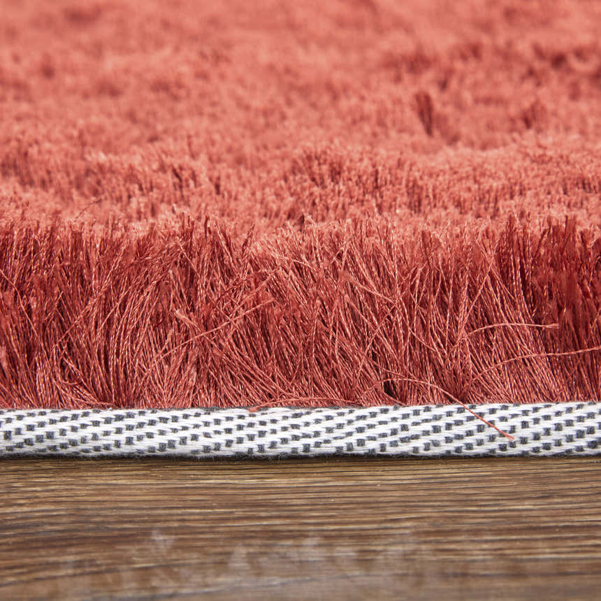 Close-up of the Feizy Indochine Modern Solid Area Rug in red and orange, showing texture and hand-tufted construction. Pile