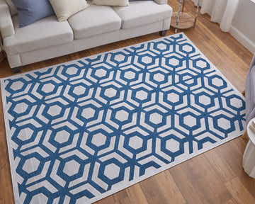 Living room with a white sofa and Feizy Saphir Mira blue and white geometric area rug on a wood floor. Roomscene-Rectangle