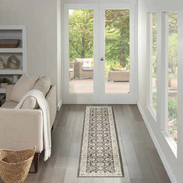 Hallway with Nourison Serenity Home Ivory Grey Blue Vintage runner rug, leading to outdoor patio view. Neutral decor.