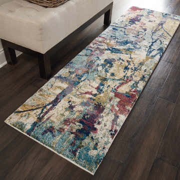 Entryway with Nourison Fusion Cream Multicolor rug, wood floors, and upholstered bench.