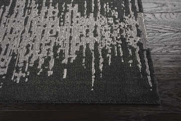 Close-up of the Nourison Twilight Flint rug showing its abstract silver pattern and dark gray background.