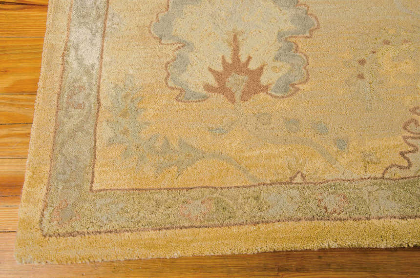 Close-up of the handmade Nourison Jaipur Light Gold Persian rug showing wool texture and floral pattern.