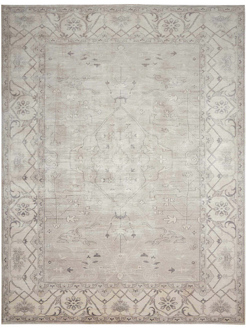 Close-up of the Nourison Aldora Silver Vintage Area Rug, featuring a faded floral pattern and geometric border.