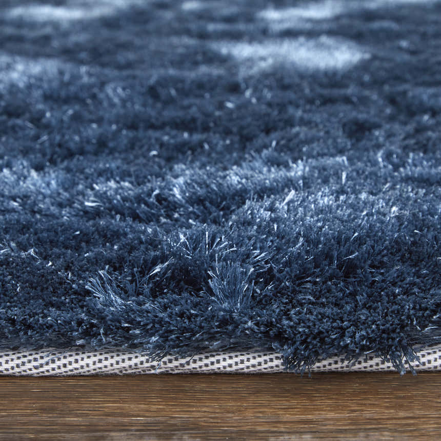 Close-up of the textured Feizy Indochine Indigo Area Rug, showing the blue and black fibers and rug construction. Pile