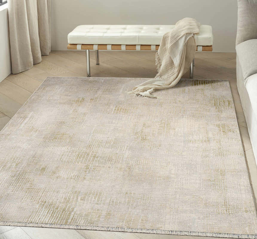 Modern living room with a Calvin Klein CK089 Drift Grey rug, white bench, and light wood floors.