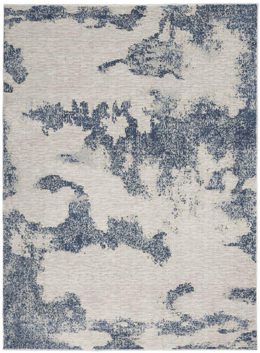 Close-up of the Nourison Etchings Ivory/Light Blue area rug, featuring a modern abstract pattern and soft texture.