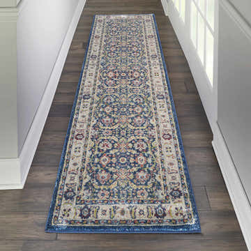 Hallway with Nourison Ankara Global Navy Multicolor rug runner on dark wood floor. Traditional style.
