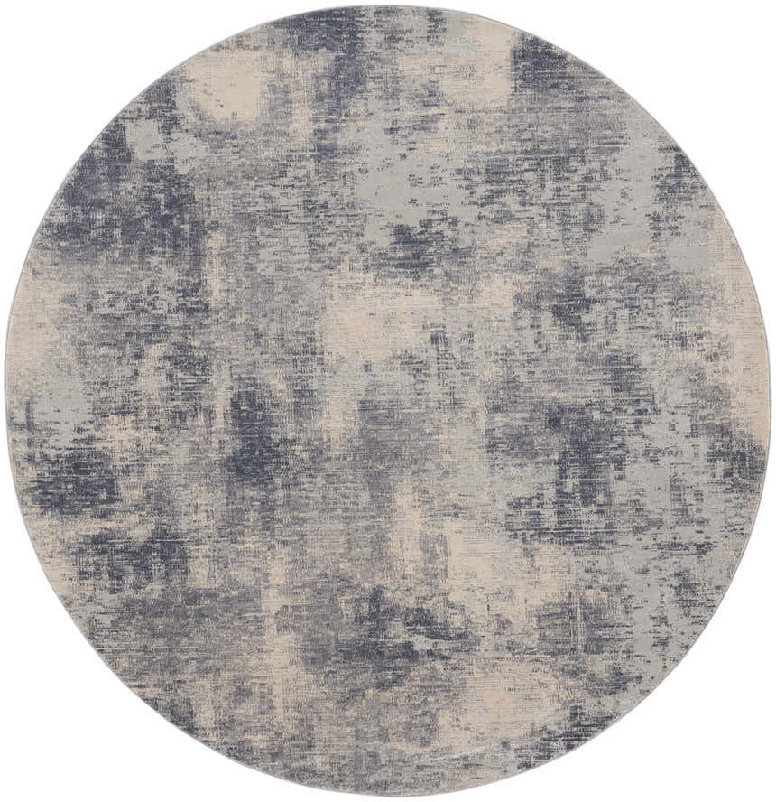Close-up of the round Nourison Rustic Textures Blue Ivory rug featuring a distressed, abstract pattern.