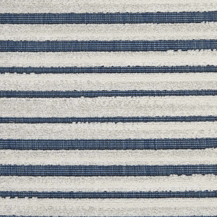 Close-up of the Nourison Key Largo Blue rug. Features a contemporary striped pattern in light blue and white.