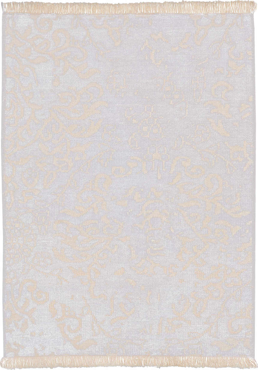 Close-up of Nourison Aldora Royal Vintage rug. Features a subtle royal and gold vintage pattern and fringe.