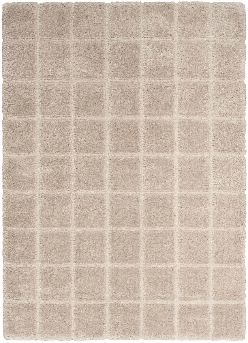 Close-up of the beige DKNY West End Ave rug. Shag texture with a subtle square pattern.