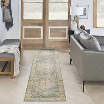 Entryway with gray bench, leather sofa, and Nourison Astra Silver Blue Vintage Runner Rug on light wood floors.