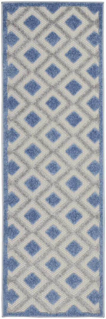 Close-up of the Nourison Aloha Blue Grey Modern Area Rug. Features a diamond pattern in shades of blue, gray, and white.