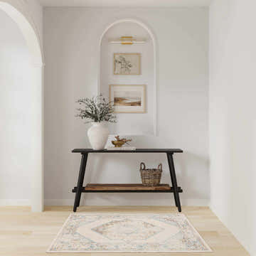 Entryway with a Nourison Astra Ivory Blue Vintage Rug, console table, and neutral decor.