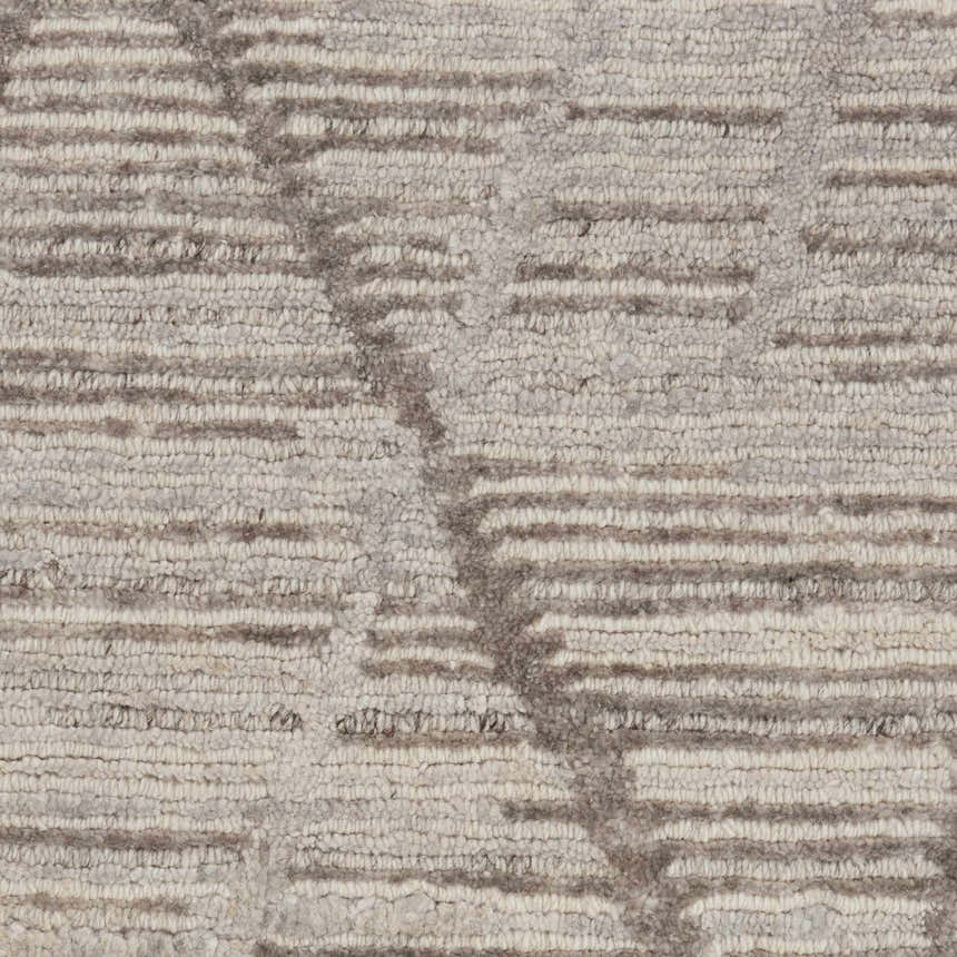 Close-up of the Nourison OCEAN Stone rug showing its sandstone color and horizontal stripe pattern.