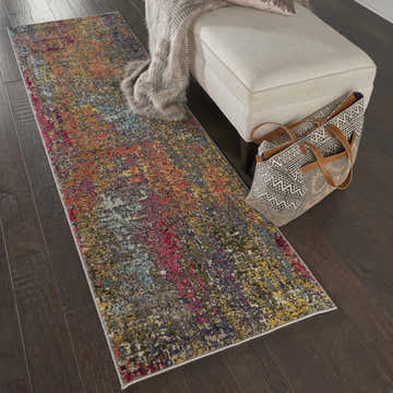 Entryway with Nourison Celestial Sunset runner rug, beige bench, and patterned tote bag on dark wood floor.