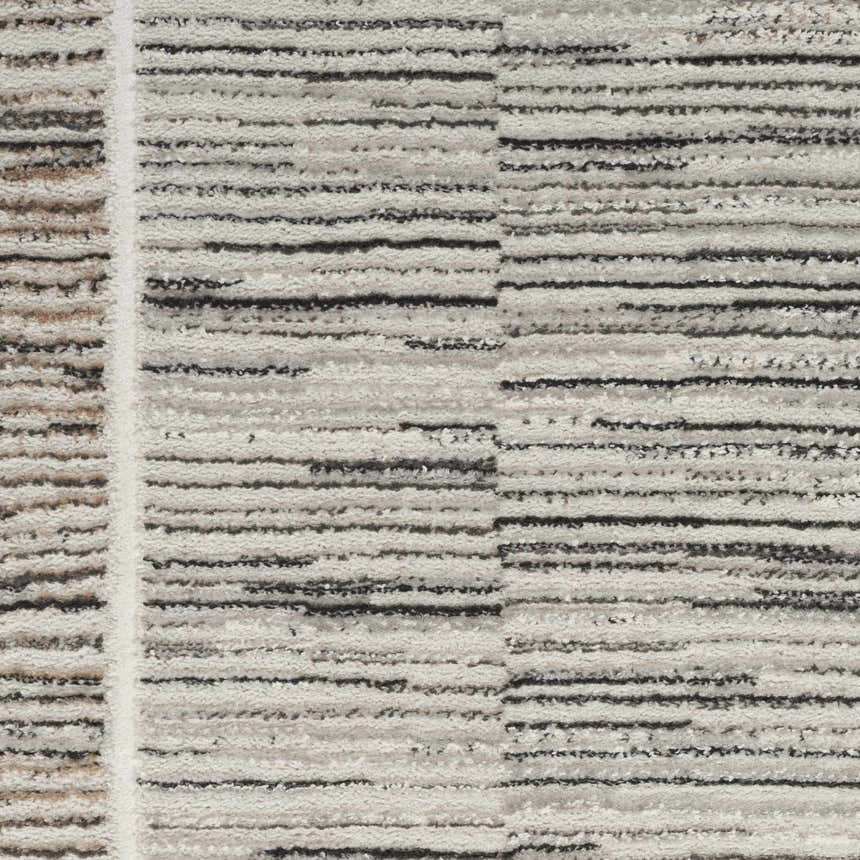 Close-up of the Nourison Desire Charcoal Grey rug, showing its striped pattern and textured polyester material.