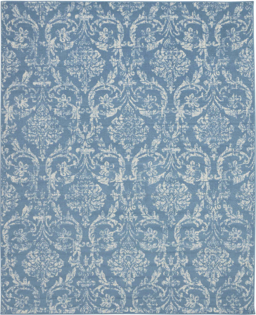 Close-up of Nourison Jubilant Blue Vintage Indoor Area Rug. Light blue rug with distressed white floral damask pattern.