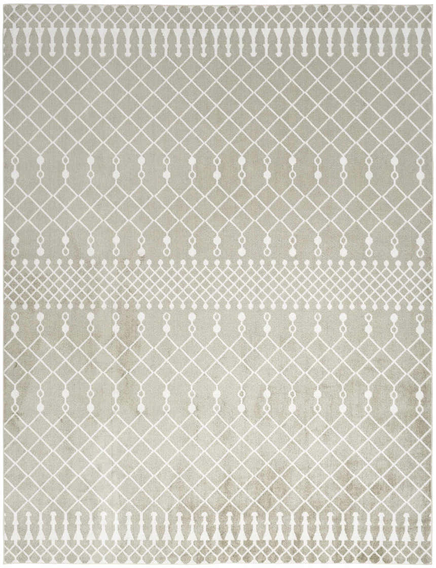 Close-up of Nourison Astra Sage Bohemian Rug. Muted sage rug with white geometric diamond and tassel pattern. Machine-made texture.