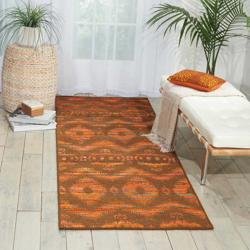 Bright room featuring Nourison Spectrum Flame Chocolate runner rug, white bench, and potted plants.