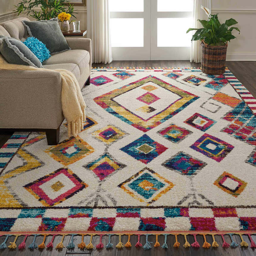 Living room with a beige couch and the Nourison Nomad Ivory Multicolor Tribal Area Rug.