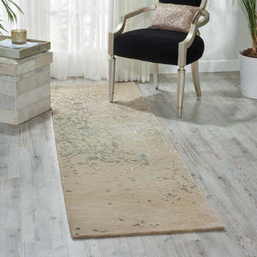 Entryway with Nourison Opaline Beige Vintage runner rug, black chair, and light wood floors.