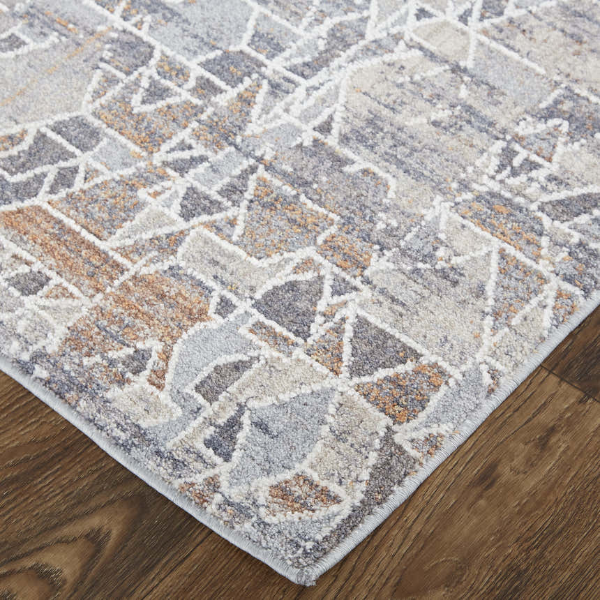 Close up of Feizy Francisco rug. Gray, blue, and orange abstract design on a transitional style area rug. Corner