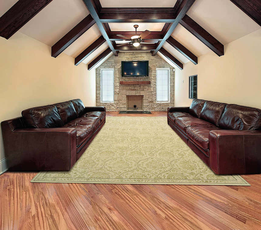 Living room scene with brown leather sofas and Nourison Regal Gravel Persian rug.