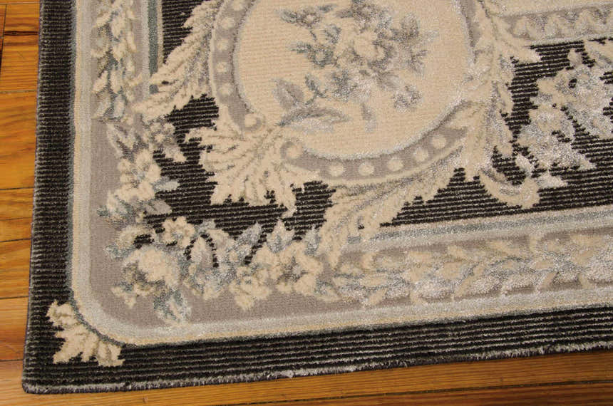 Close up of the Michael Amini Platine Charcoal rug showing vintage floral design, taupe, and charcoal colors.