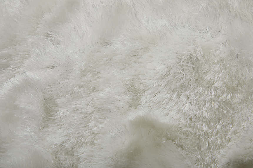Close-up of the plush texture of the Feizy Indochine Modern Solid White Area Rug. Texture