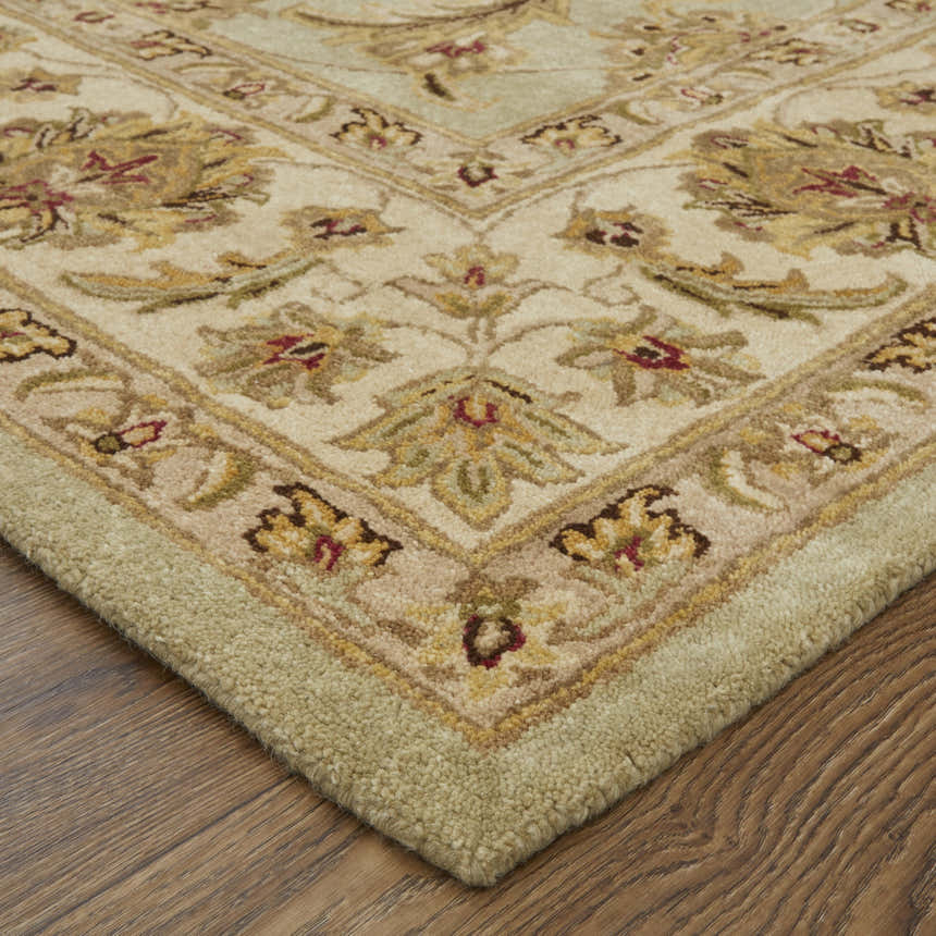 Close-up of the hand-tufted Feizy Wagner Traditional Oriental rug. Tan, brown, and green floral pattern. Wool and cotton blend. Corner