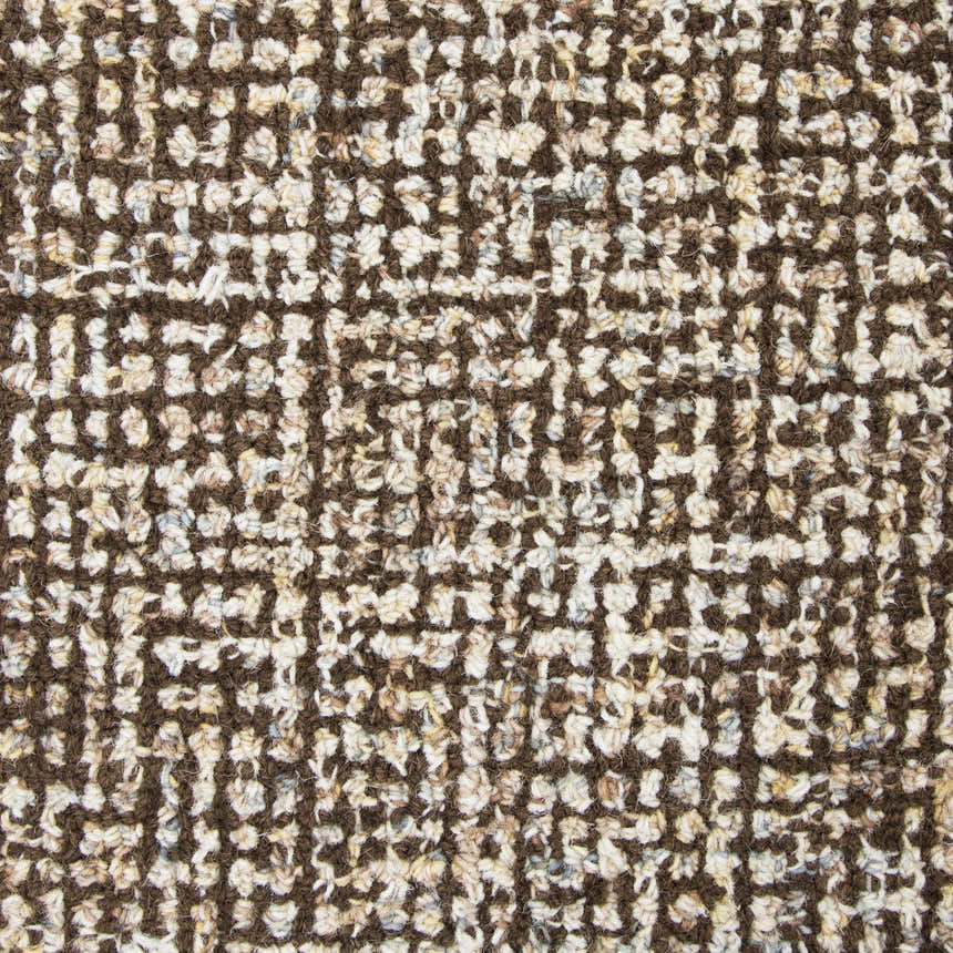 Close-up of the hand-tufted Rizzy BR360A area rug. The wool rug has a textured, dark red and white geometric pattern. Texture